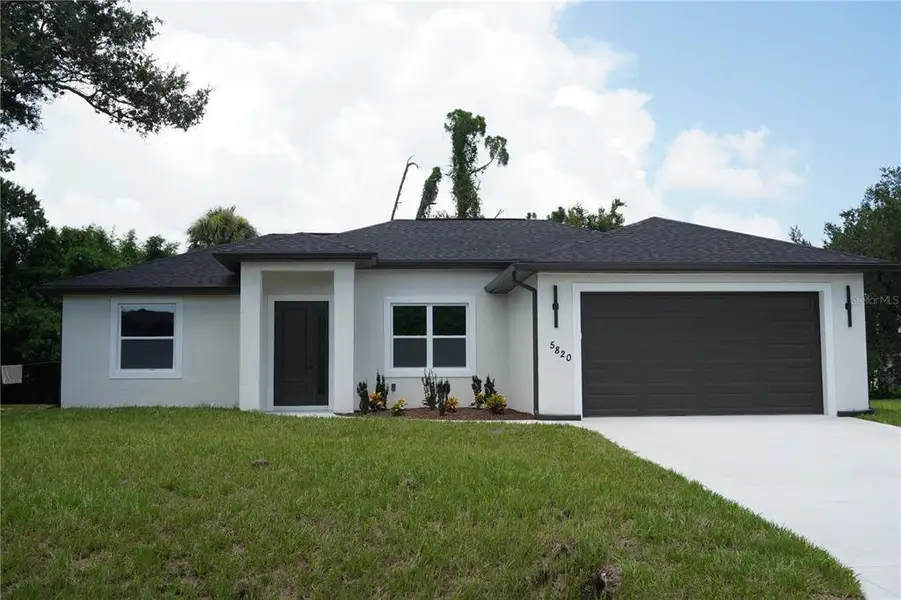 Front exterior of a new home in , North Port, FL, highlighting curb appeal (Image 1). Front exterior of a new home in , North Port, FL, highlighting curb appeal (Image 1).