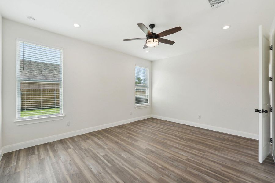 Primary Bedroom with baseboards, wood-style vinyl flooring, and ceiling fan Primary Bedroom with baseboards, wood-style vinyl flooring, and ceiling fan