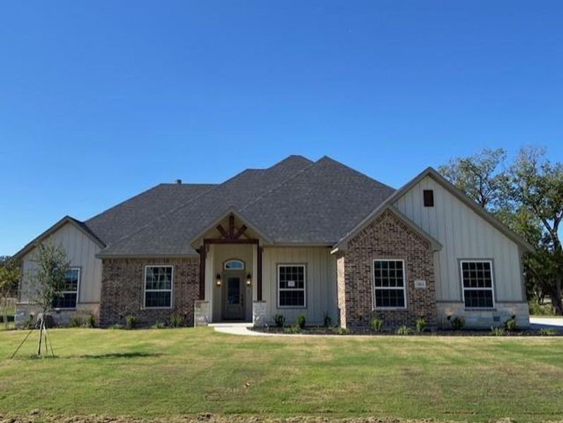 Front exterior of a new home in , Springtown, TX, highlighting curb appeal (Image 1). Front exterior of a new home in , Springtown, TX, highlighting curb appeal (Image 1).