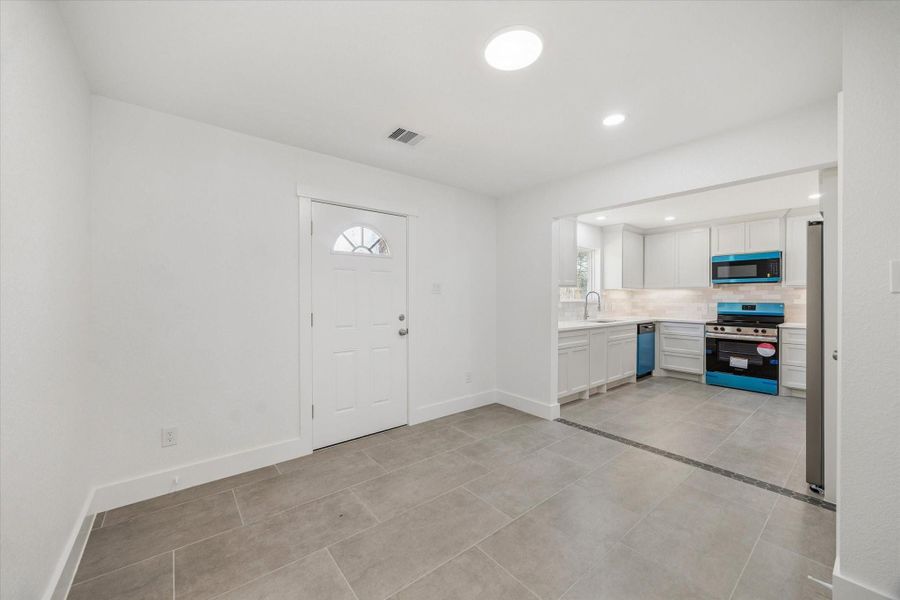 Dining area looking into open kitchen.