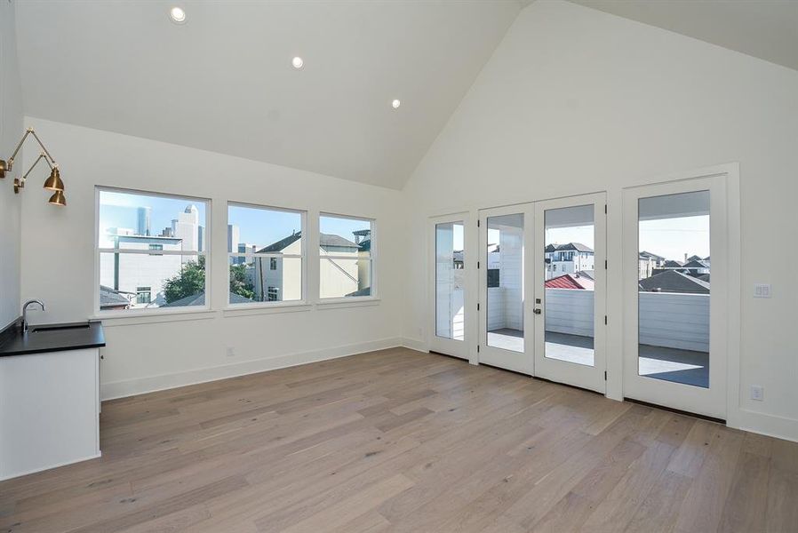 Large and bright game room that opens to a spacious outdoor, covered patio.