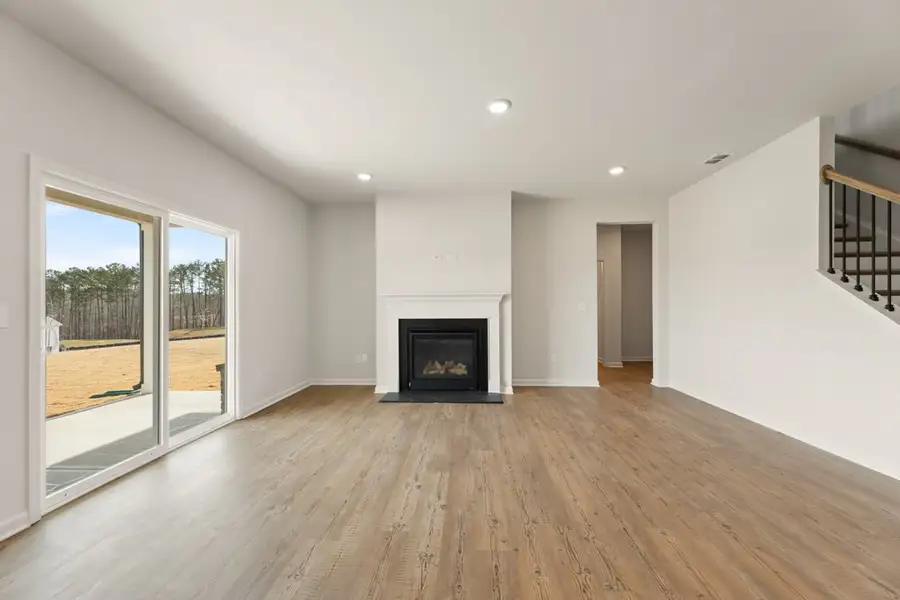 A large living room with a fireplace. A large living room with a fireplace.