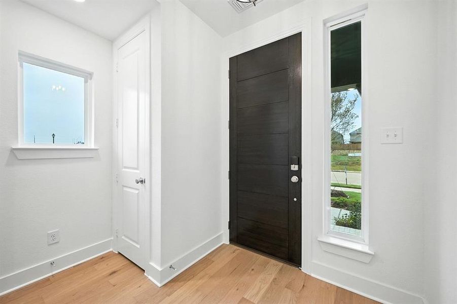 Foyer entrance featuring light wood-type flooring Foyer entrance featuring light wood-type flooring