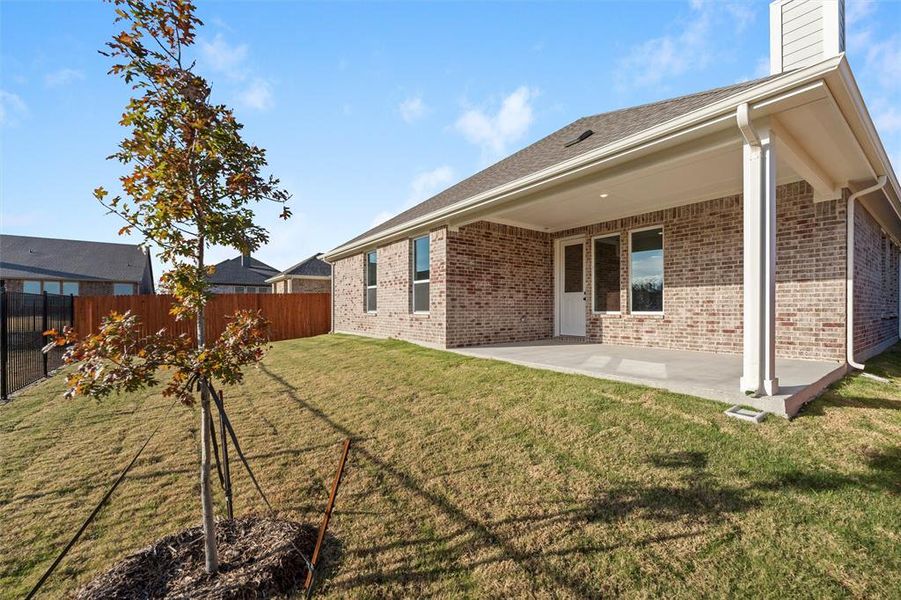 Rear view of property with a patio area, brick siding, a fenced backyard, roof with shingles, and a chimney Rear view of property with a patio area, brick siding, a fenced backyard, roof with shingles, and a chimney