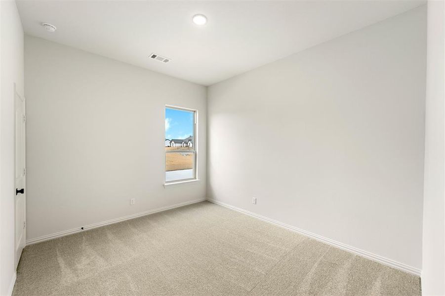 Unfurnished room with light colored carpet and baseboards