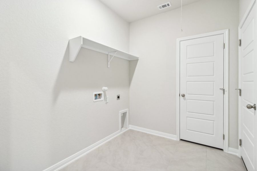 Laundry room in the Briscoe floorplan at a Meritage Homes community.