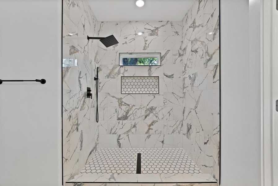 Bathroom with a marble finish shower