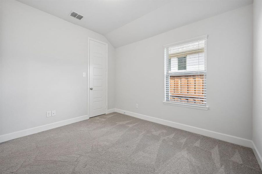 Bedroom featuring light gray carpeting, white walls, white trim, and a window with blinds