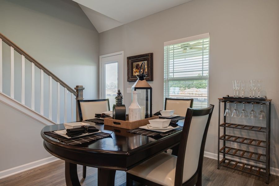 Breakfast area with window and back glass door with "in door" blinds.