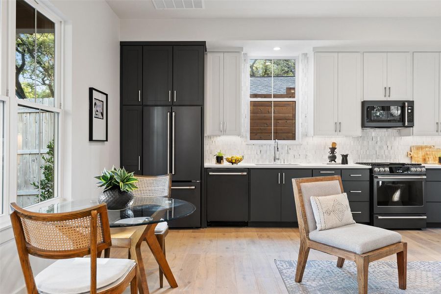 Kitchen featuring stainless steel range with gas cooktop, backsplash, paneled built in fridge, and dishwasher