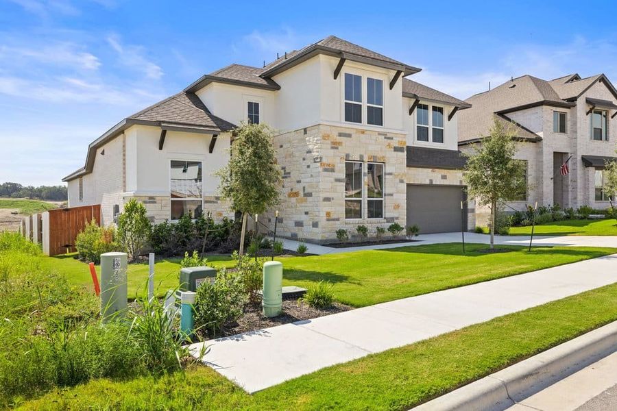 Front exterior of a new home in Lariat, Liberty Hill, TX, highlighting curb appeal (Image 30).