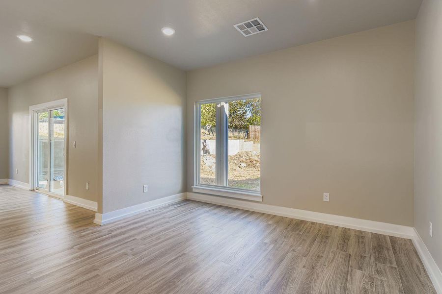 Empty room featuring light wood-style floors and recessed lighting