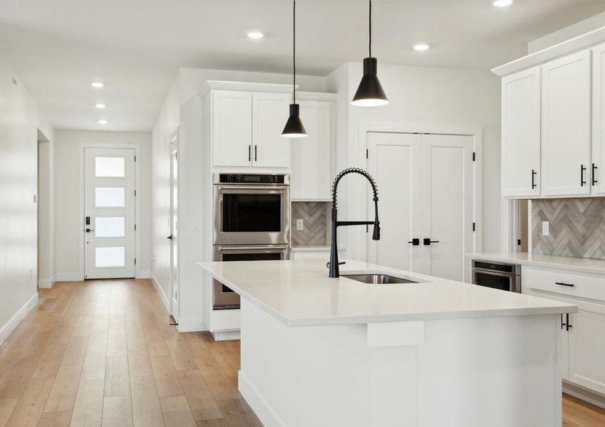 The foyer of the home opens up into the kitchen.