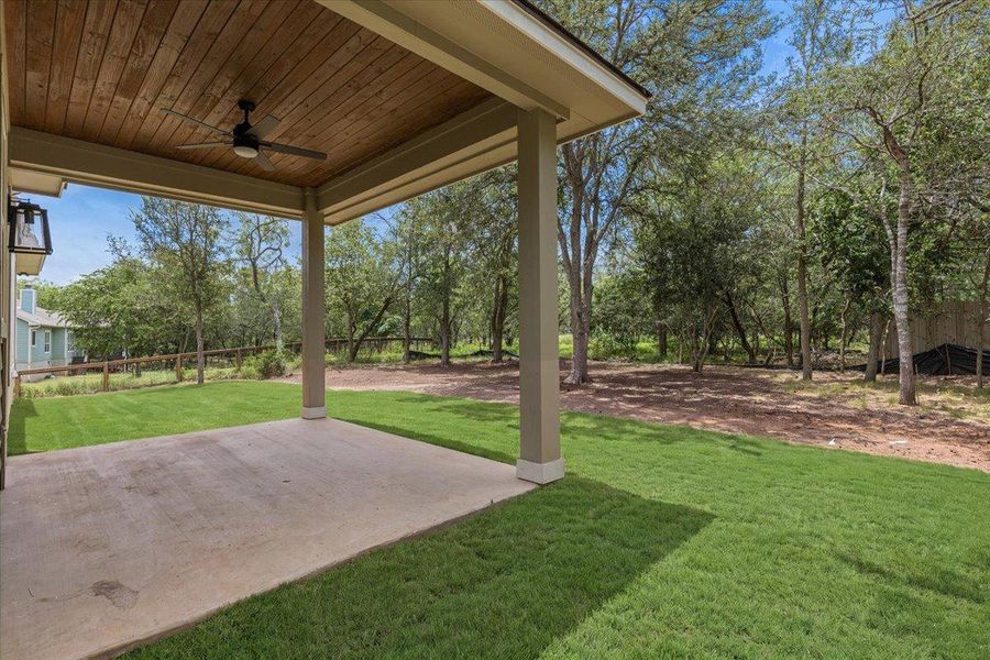 Back covered patio with large privacy backyard with trees