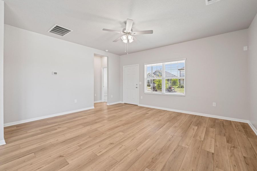 Unfurnished room featuring a ceiling fan and light wood-style floors Unfurnished room featuring a ceiling fan and light wood-style floors