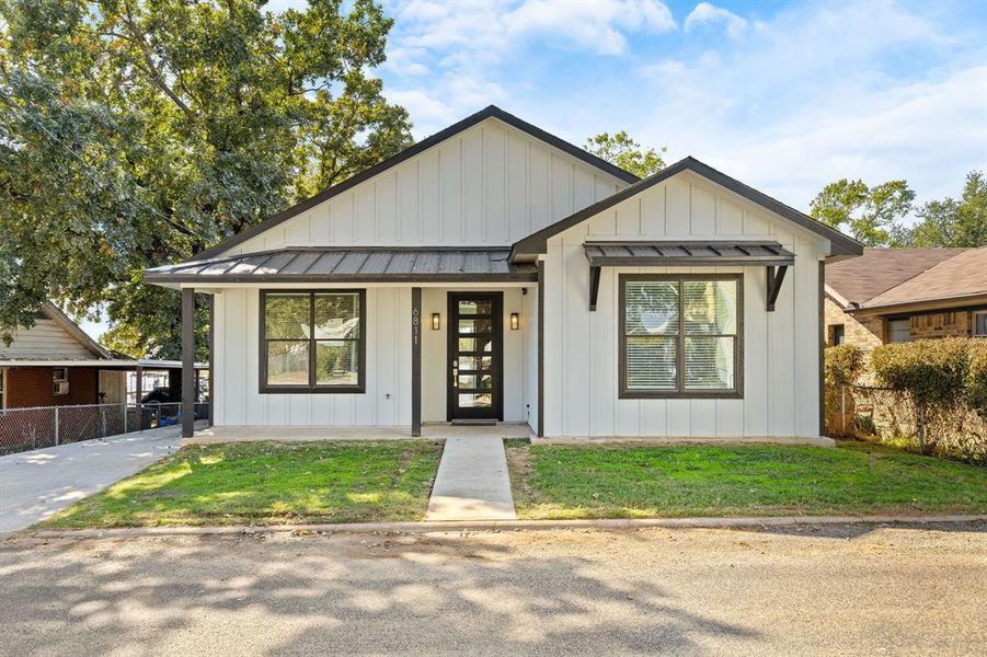View of front of property featuring board and batten siding, a standing seam roof, a metal roof, and a porch