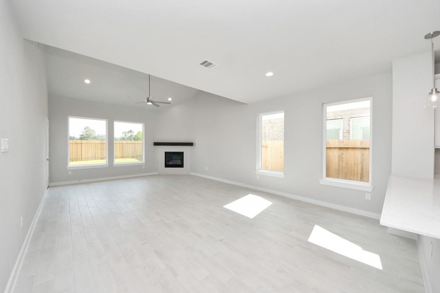 Welcome family and guests to your charming living room! With its high ceilings, recessed lighting, ceiling fan, custom paint, beautiful flooring, and large windows that let in abundant natural light, this room is perfect for gatherings. Welcome family and guests to your charming living room! With its high ceilings, recessed lighting, ceiling fan, custom paint, beautiful flooring, and large windows that let in abundant natural light, this room is perfect for gatherings.