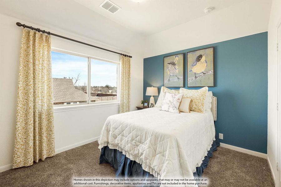 Bedroom with teal accent wall, carpet flooring, large window, and queen bed with white bedding Bedroom with teal accent wall, carpet flooring, large window, and queen bed with white bedding