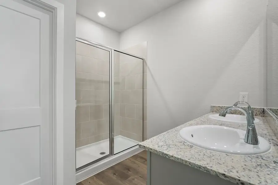 A bathroom with a glass shower. A bathroom with a glass shower.