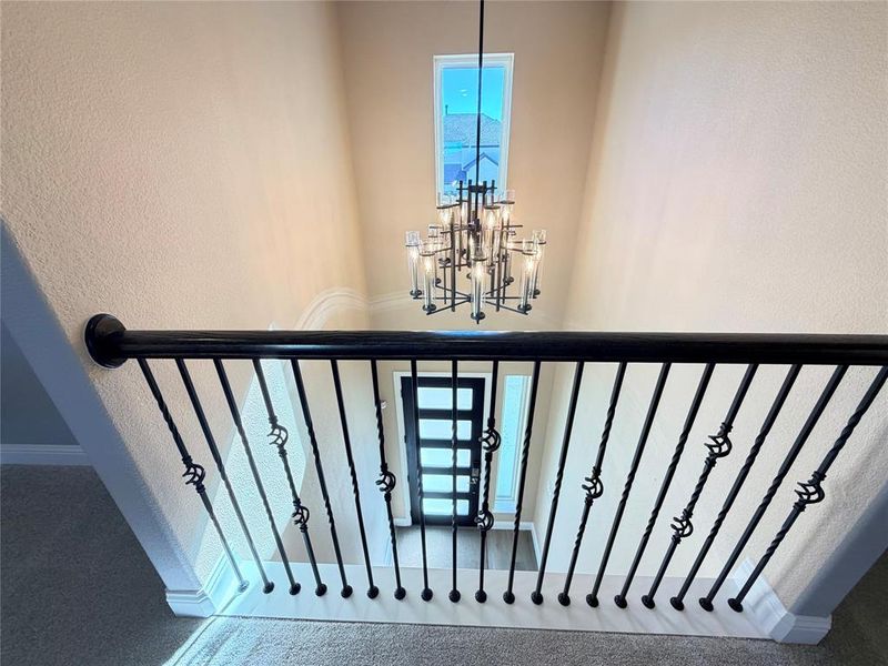 Stairway with a chandelier and a textured wall Stairway with a chandelier and a textured wall