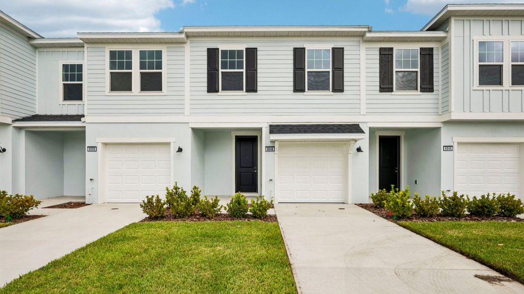 Front exterior of a new home in Twin Oaks, Zephyrhills, FL, highlighting curb appeal (Image 1). Front exterior of a new home in Twin Oaks, Zephyrhills, FL, highlighting curb appeal (Image 1).