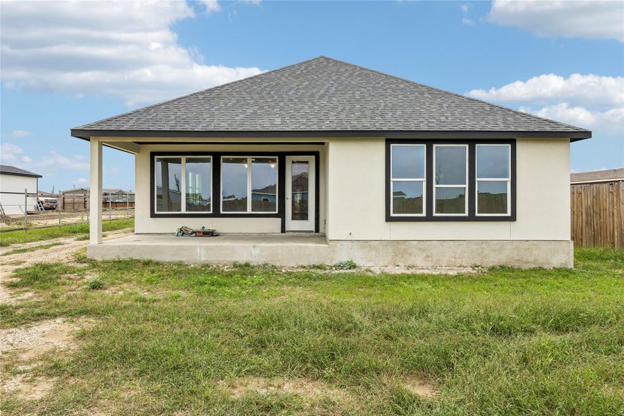 A newly constructed residence features an inviting covered patio, perfect for outdoor leisure.