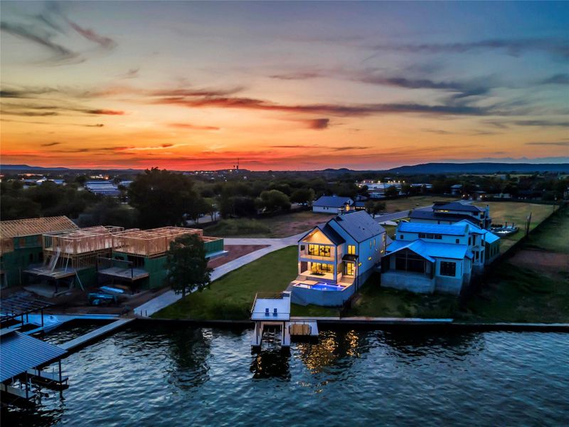 Aerial view at dusk of a water view and a residential view