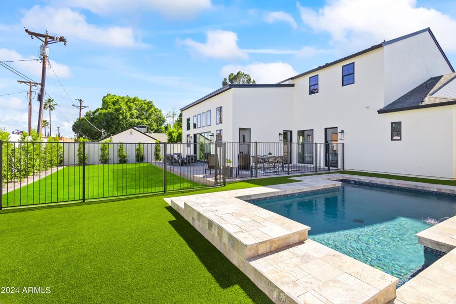 Turf and sparkling pool with fence