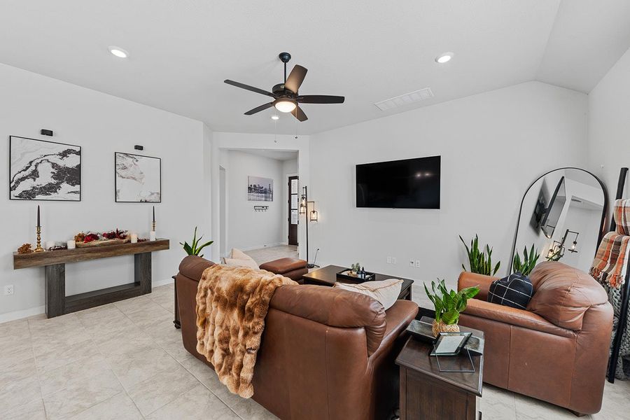 Living room featuring ceiling fan and light tile patterned floors