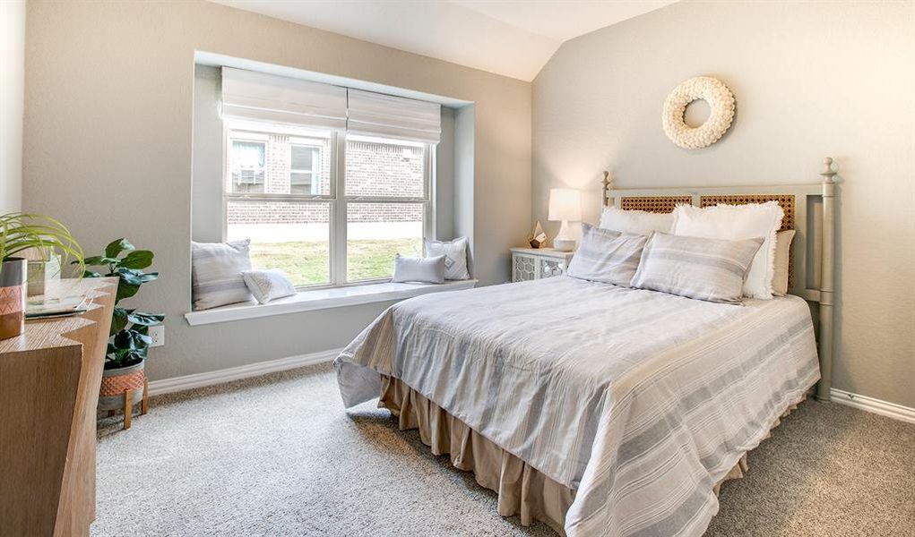 Bedroom with lofted ceiling and carpet flooring Bedroom with lofted ceiling and carpet flooring