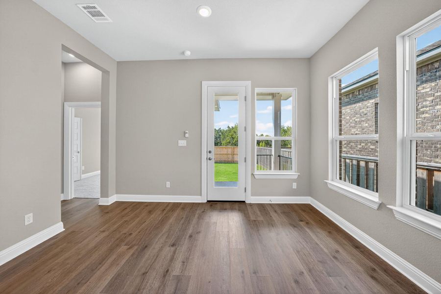 Doorway with wood finished floors, healthy amount of natural light, and recessed lighting Doorway with wood finished floors, healthy amount of natural light, and recessed lighting