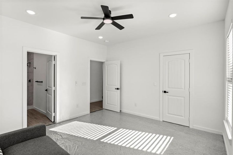 Unfurnished bedroom with a ceiling fan, recessed lighting, and light colored carpet