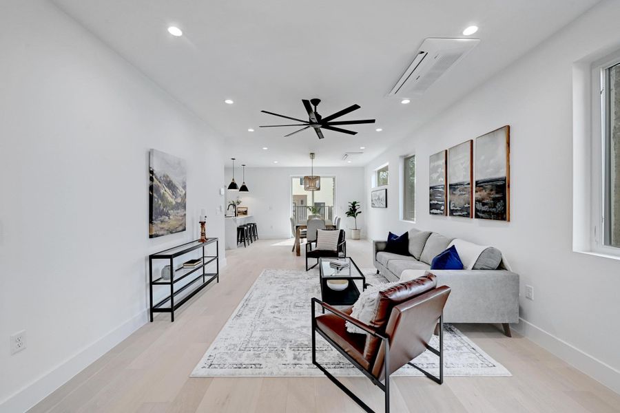 Living area with recessed lighting, light wood-style flooring, and ceiling fan