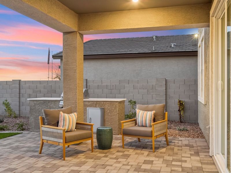 A patio with a fireplace and a chair. A patio with a fireplace and a chair.