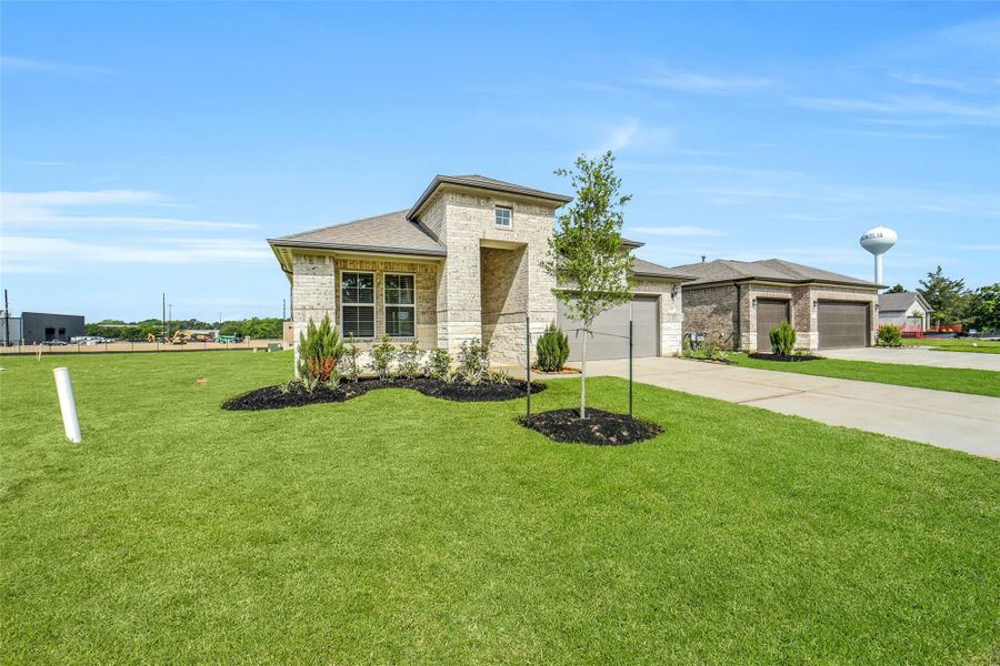 Front exterior of a new home in Windmill Estates, Magnolia, TX, highlighting curb appeal (Image 28).