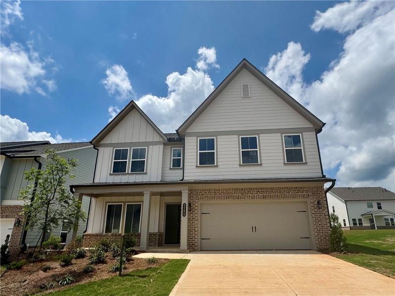 Front exterior of a new home in Eastlyn Crossing - Single Family, Flowery Branch, GA, highlighting curb appeal (Image 1). Front exterior of a new home in Eastlyn Crossing - Single Family, Flowery Branch, GA, highlighting curb appeal (Image 1).