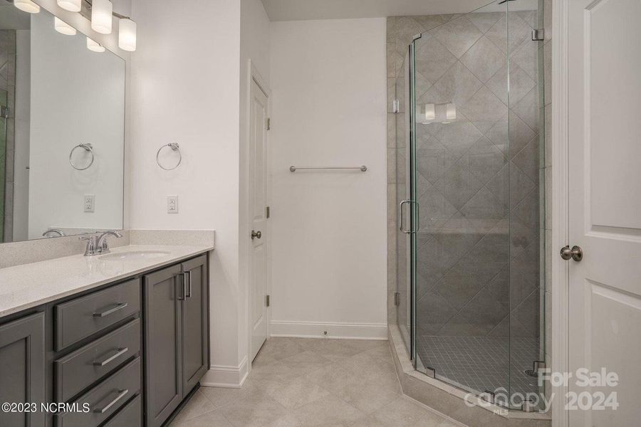 Concept photo of Primary Bath with dual vanity, walk in shower, water closet & tile floors!