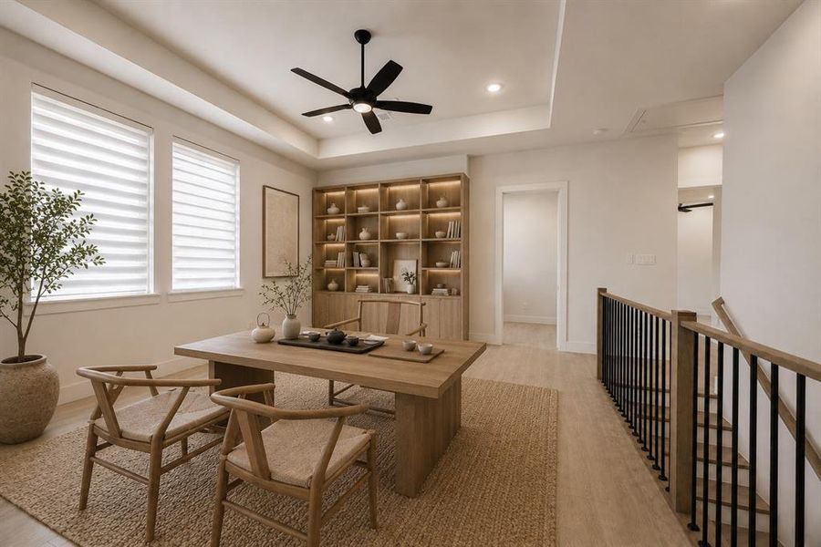Dedicated space featuring a built-in illuminated bookshelf, wood-finish flooring, and a tray ceiling with recessed lighting