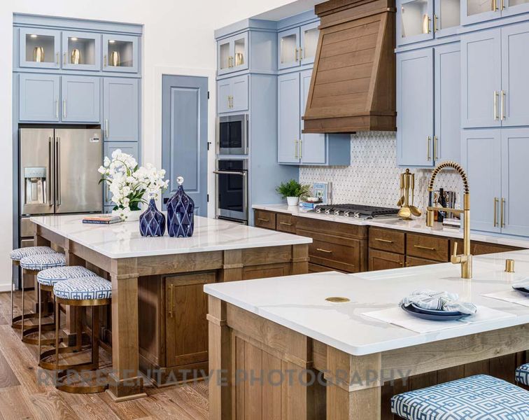 Kitchen featuring appliances with stainless steel finishes, custom exhaust hood, a kitchen breakfast bar, and a spacious island Kitchen featuring appliances with stainless steel finishes, custom exhaust hood, a kitchen breakfast bar, and a spacious island