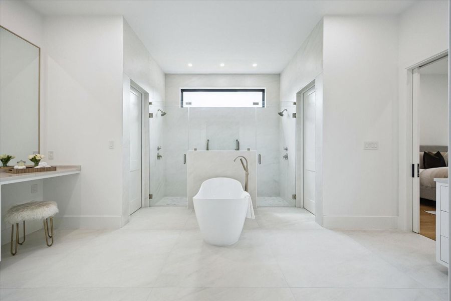 Spa-like primary bath with freestanding tub, and his and hers water closet. Spa-like primary bath with freestanding tub, and his and hers water closet.