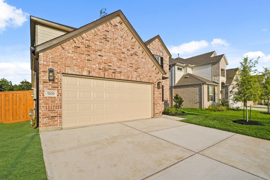 Front exterior of a new home in Sunterra North, Katy, TX, highlighting curb appeal (Image 2). Front exterior of a new home in Sunterra North, Katy, TX, highlighting curb appeal (Image 2).