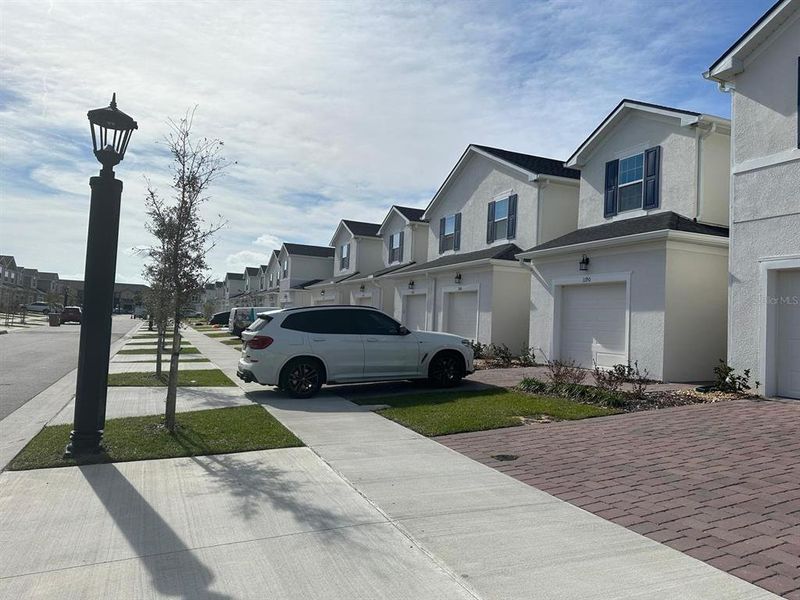 Front exterior of a new home in , Kissimmee, FL, highlighting curb appeal (Image 1).