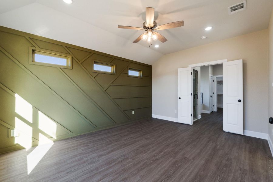 Unfurnished bedroom featuring vaulted ceiling, ceiling fan, dark wood-style floors, and recessed lighting