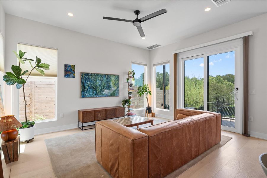 A sun-filled living space offers seamless indoor-outdoor living with a glass slider leading to a private balcony. A sun-filled living space offers seamless indoor-outdoor living with a glass slider leading to a private balcony.