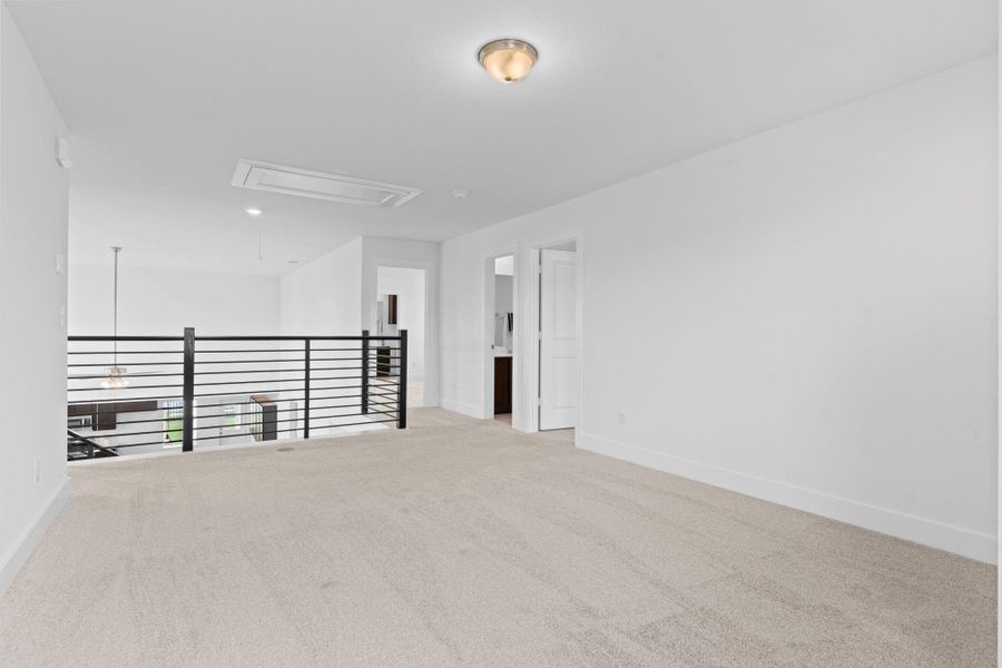 Another view of the game room showcases its expansive layout and connection to the upstairs bedrooms and bath, with plenty of space for entertaining or relaxing. Down the hallway you will discover the other guest bedrooms and more. **Image Representative of Plan Only and May Vary as Built**. Another view of the game room showcases its expansive layout and connection to the upstairs bedrooms and bath, with plenty of space for entertaining or relaxing. Down the hallway you will discover the other guest bedrooms and more. **Image Representative of Plan Only and May Vary as Built**.