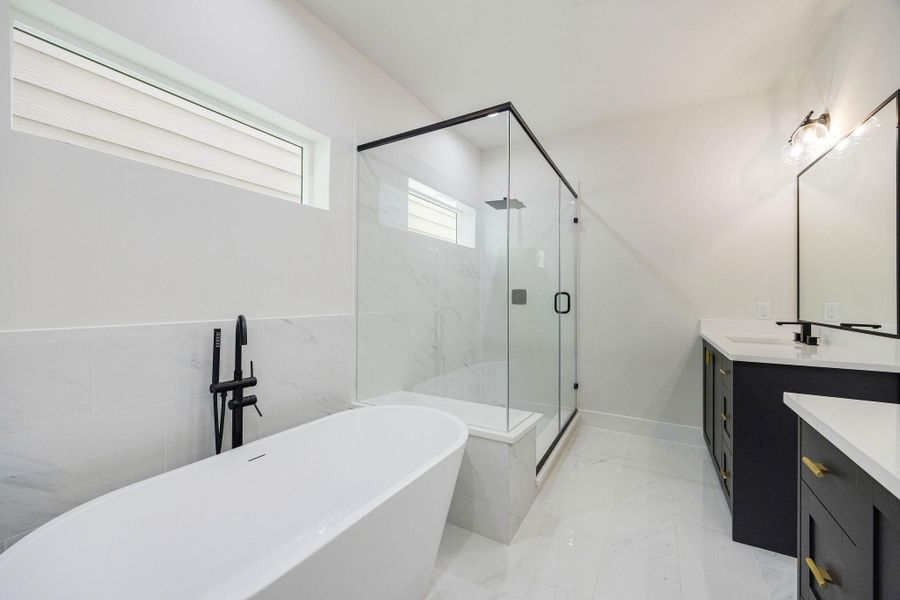 Primary bathroom with dual vanities and walk-in shower Primary bathroom with dual vanities and walk-in shower