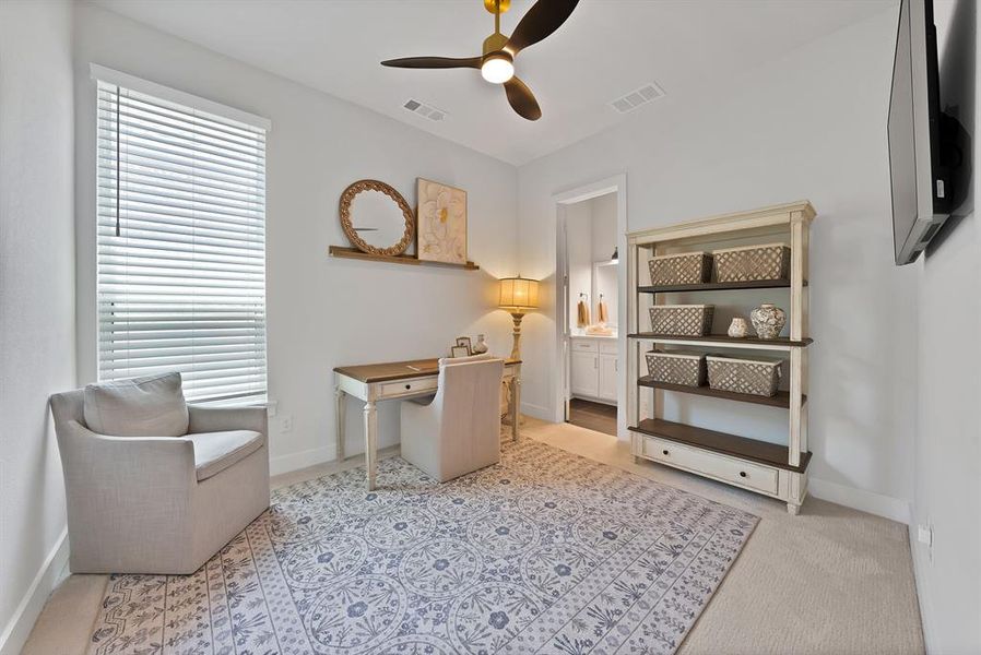 Well-lit interior space featuring neutral wall tones, a ceiling fan with integrated lighting, and a window with horizontal blinds Well-lit interior space featuring neutral wall tones, a ceiling fan with integrated lighting, and a window with horizontal blinds