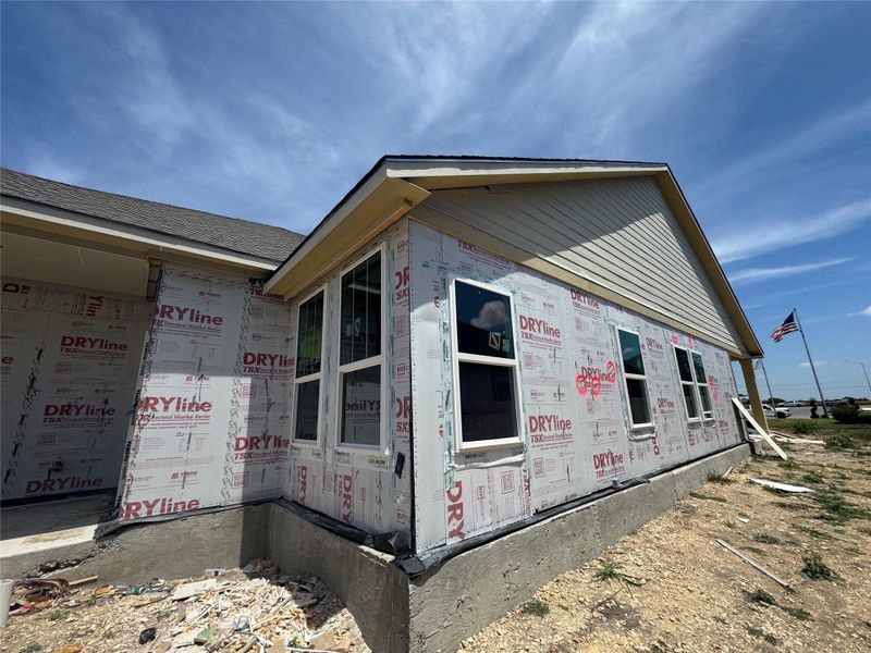 Front exterior of a new home in Village at Three Oaks, Seguin, TX, highlighting curb appeal (Image 2).