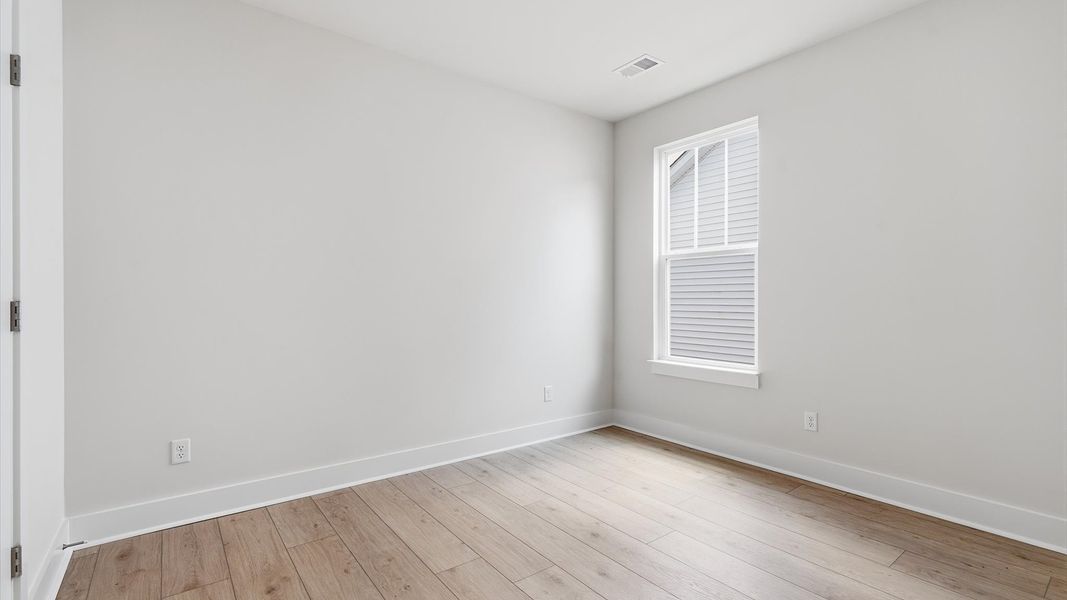 Vibrant and restful bedroom with an oversized window, refined detail, and a warm, welcoming atmosphere Vibrant and restful bedroom with an oversized window, refined detail, and a warm, welcoming atmosphere