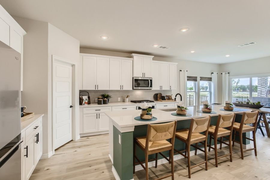 A kitchen with white cabinets.